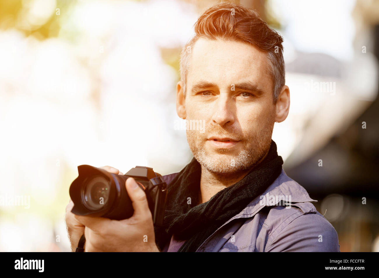 Professional photographer taking picture in city Stock Photo - Alamy