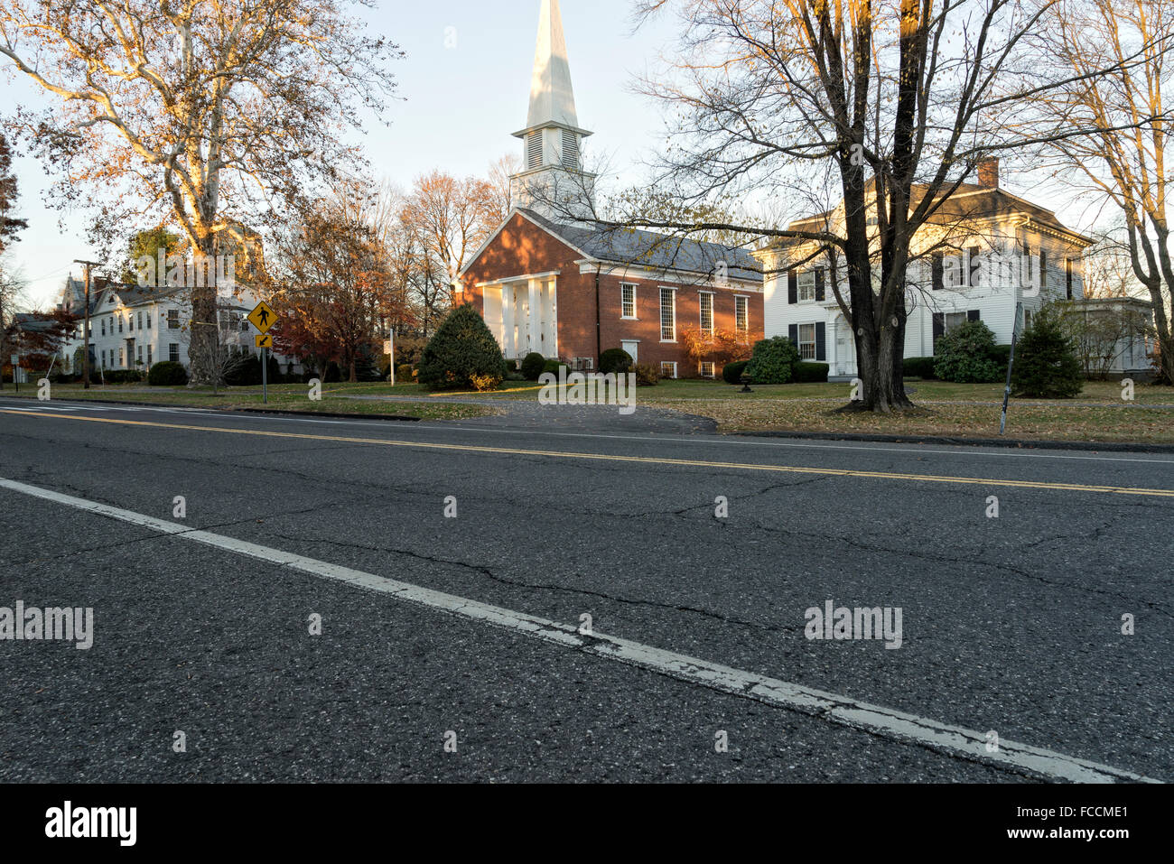 Stately HIstoric Home on the Main Street of Litchfield, CT. Next to a traditional country church with a steeple. Stock Photo