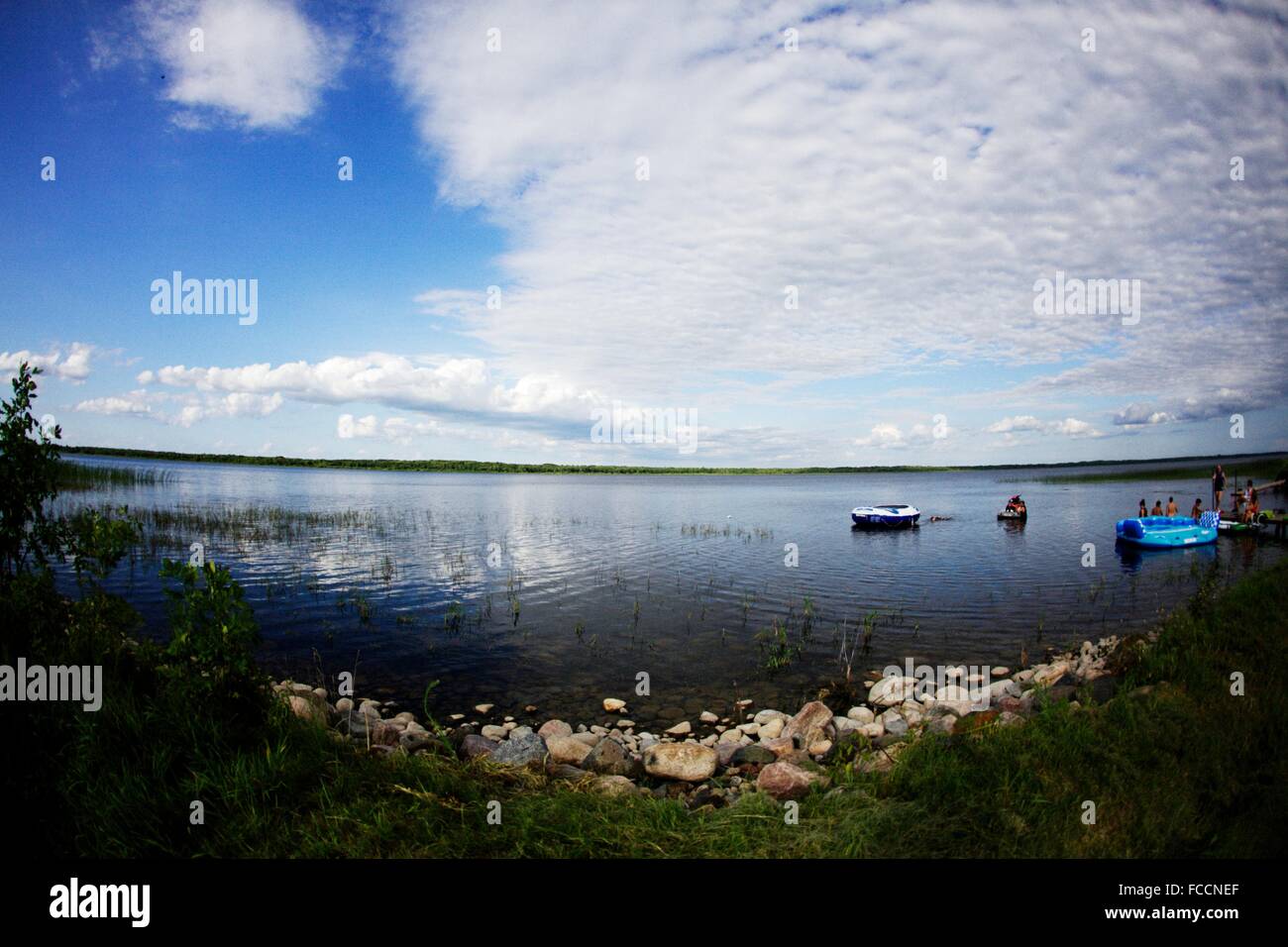 Floating Boats On Water Near Shore Stock Photo Alamy