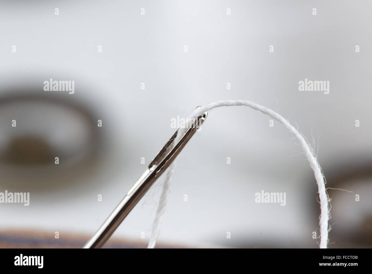 we sew buttons a sharp needle with a thread Stock Photo