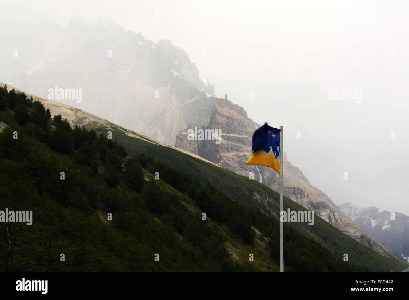 Flag On A Mountain Peak Stock Photo