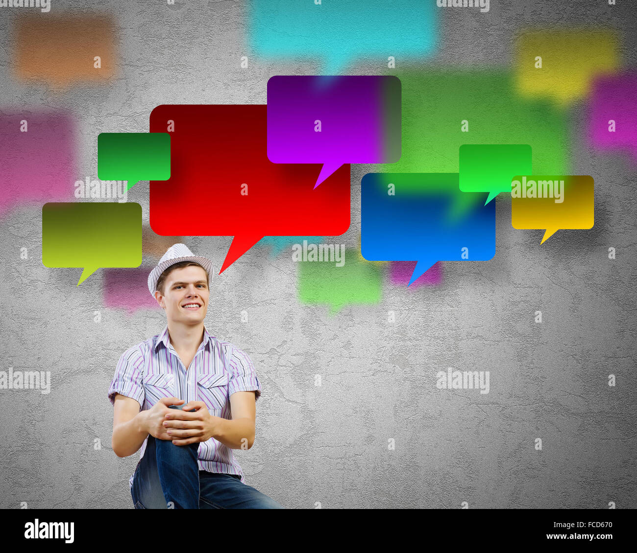 Young man in casual sitting and thinking Stock Photo - Alamy