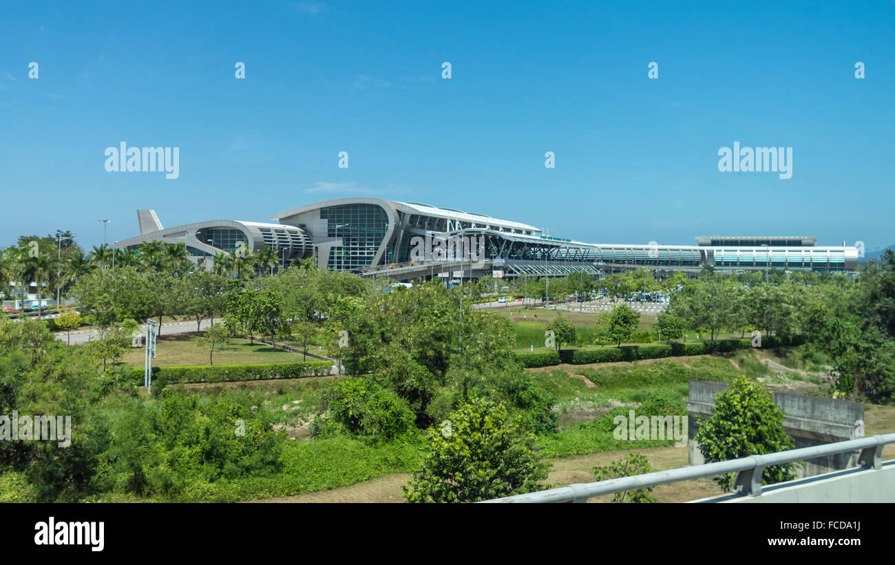 Landmark wing-shaped terminal building of KKIA Kota Kinabalu International Airport (IATA: BKI) on a sunny day. Kota Kinabalu, Sabah, Malaysia. Stock Photo