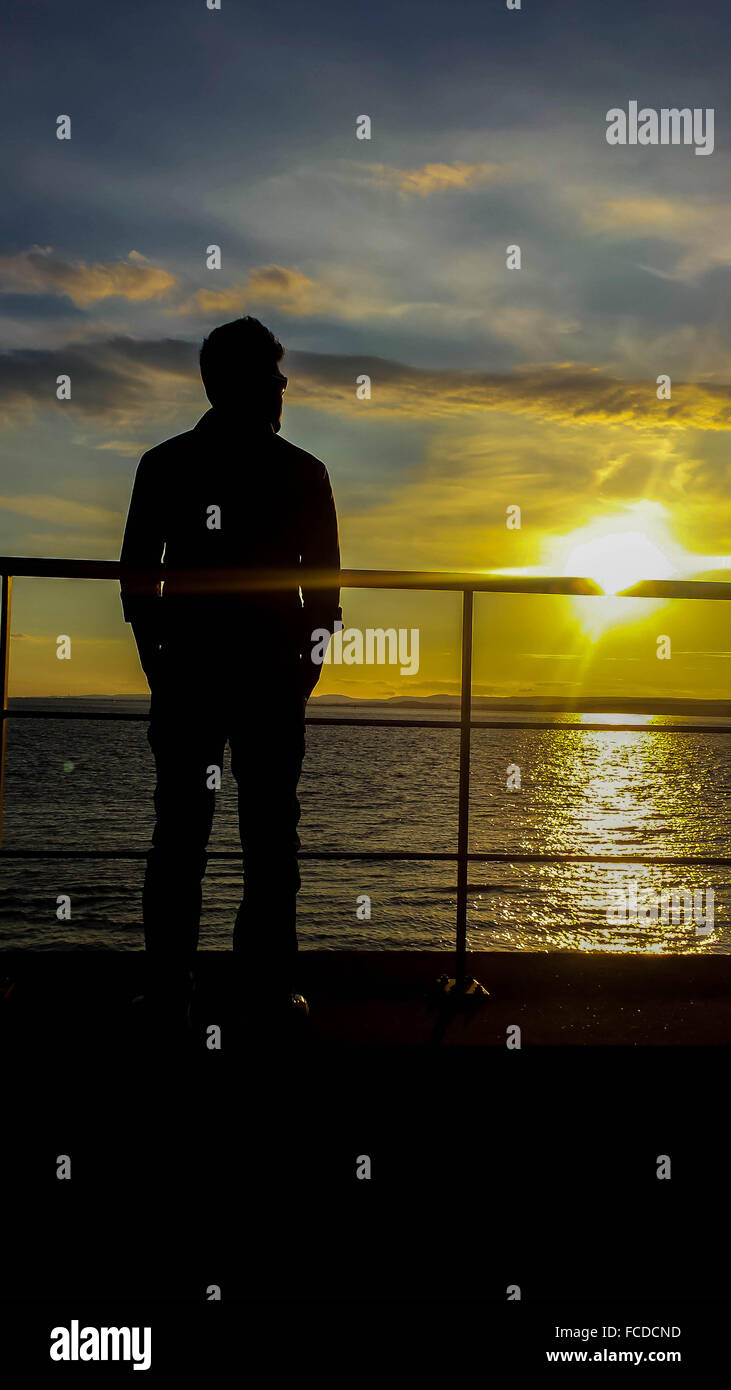 Silhouette man standing railing river hi-res stock photography and ...