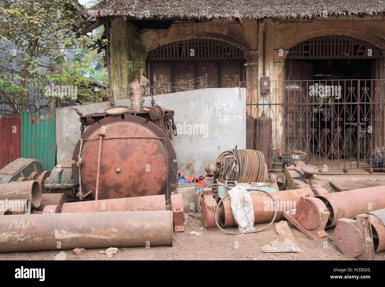 Rusty machine parts on the street outside a local workshop in Myeik ...