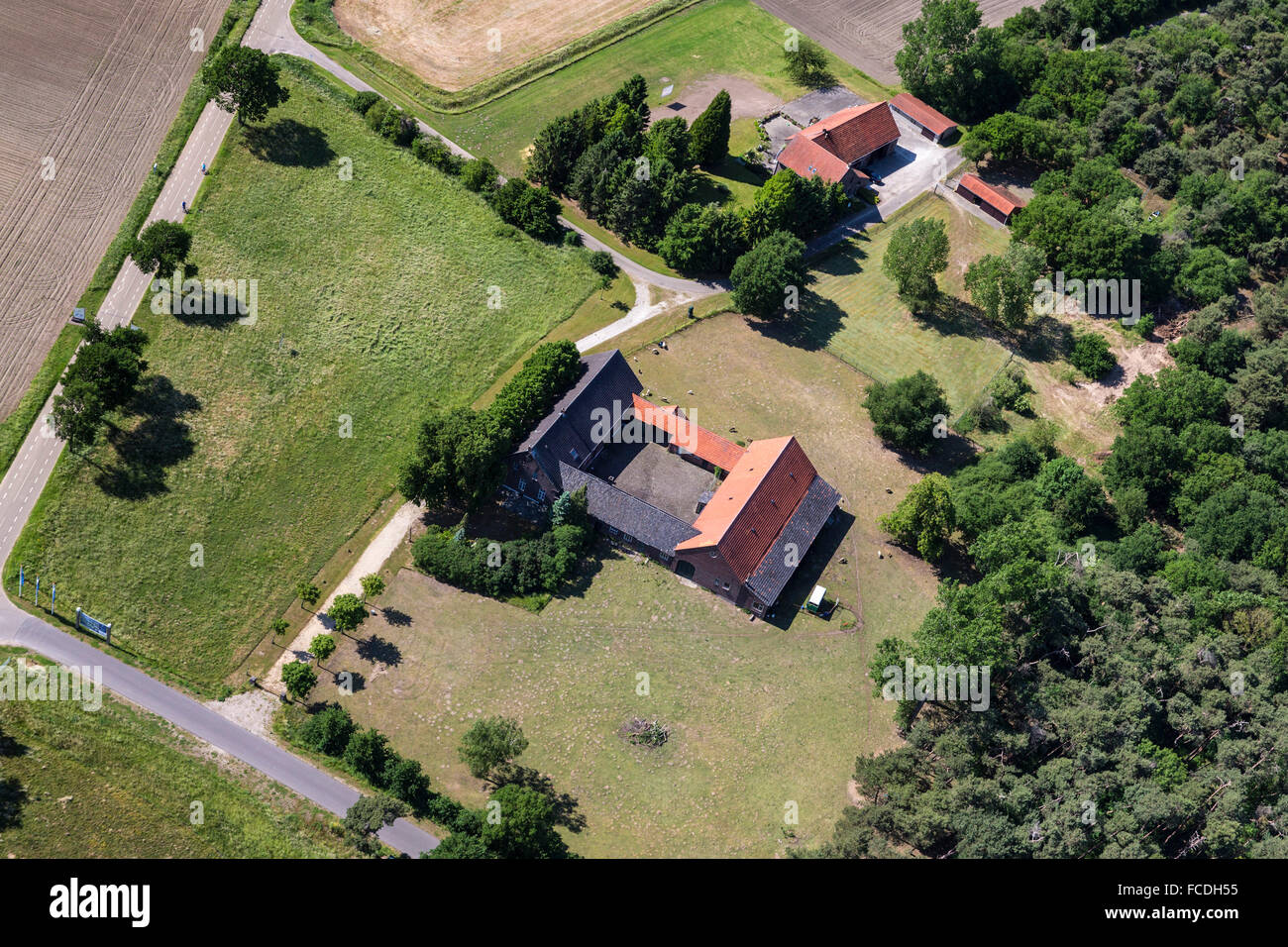 Netherlands, Bergen, Square shaped farm, typical for the area in former times. Aerial Stock Photo