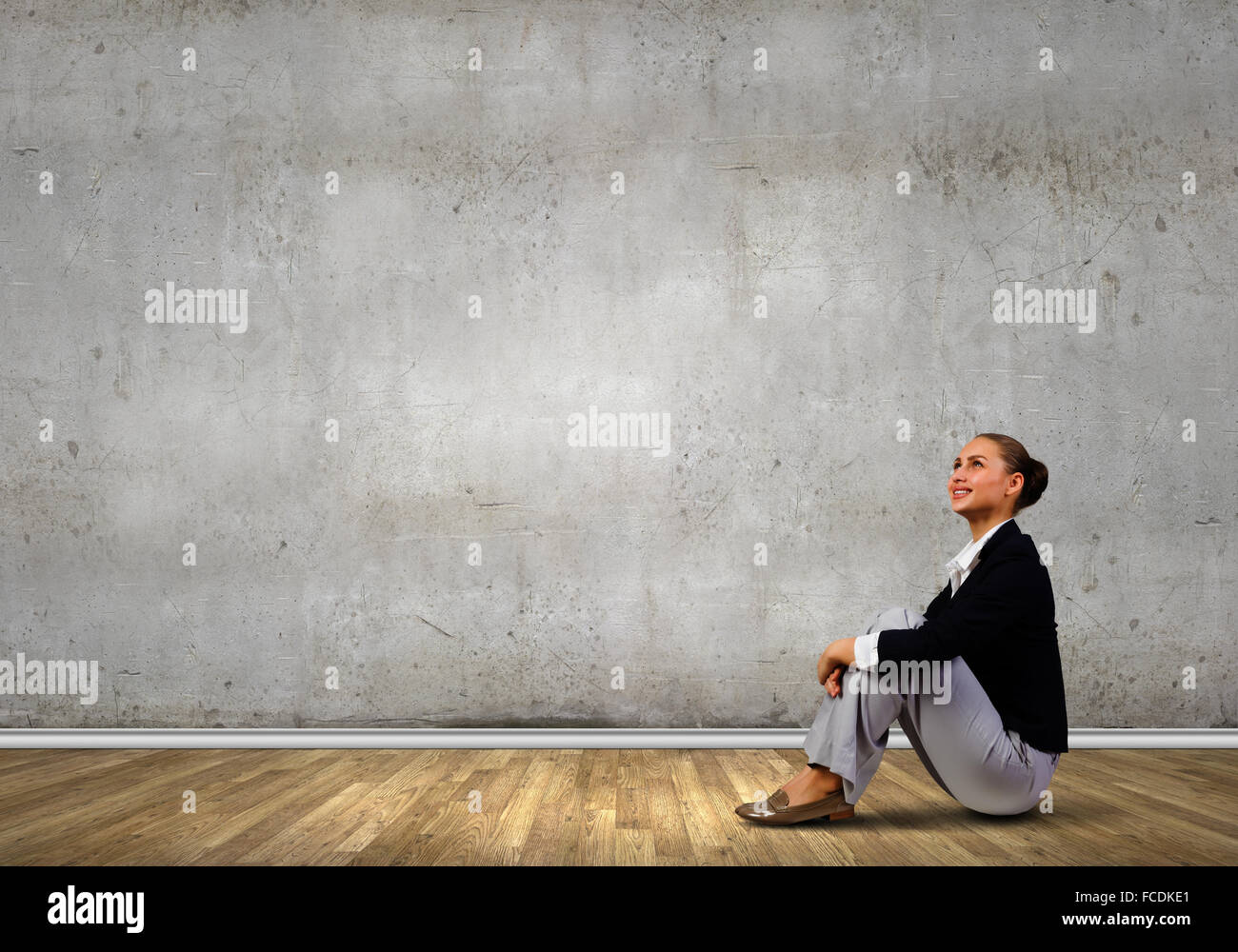 Young attractive lady sitting on floor of empty room Stock Photo - Alamy