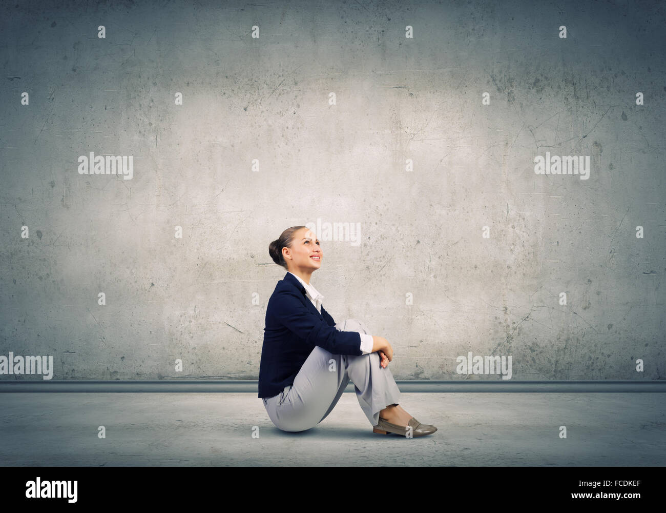 Young attractive lady sitting on floor of empty room Stock Photo - Alamy
