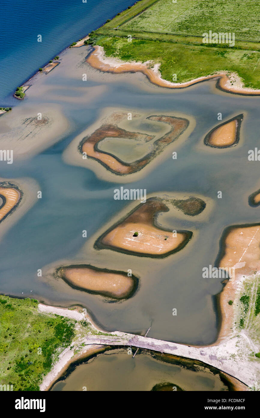 Netherlands, Stellendam, Haringvliet Lagoon, small nature reserve in flood plains. Aerial Stock Photo
