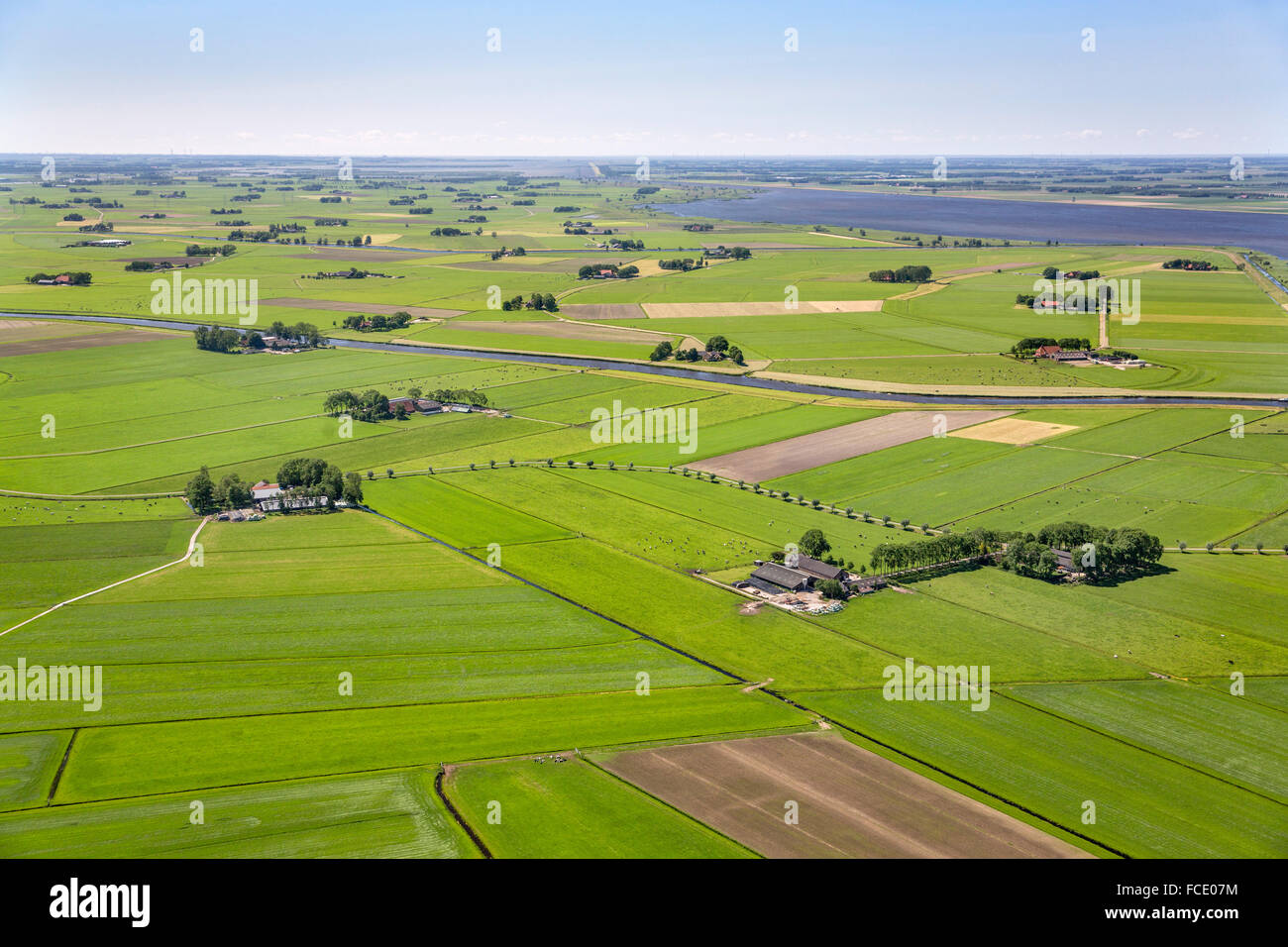 Netherlands, IJsselmuiden, Mound of IJssel river. Farmland and farms. Aerial Stock Photo