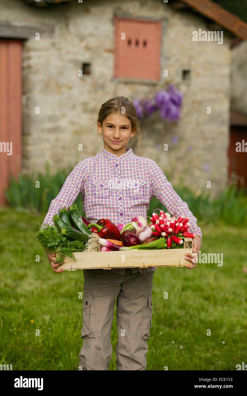 Young girl with vegetables from the garden Stock Photo - Alamy
