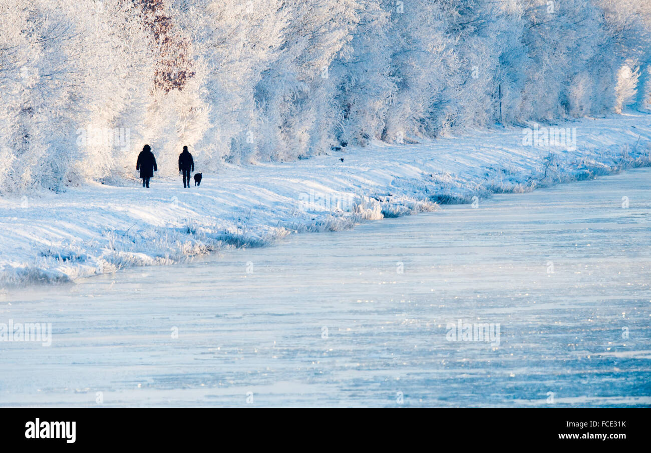 Sehnde, Germany. 22nd Jan, 2016. Two people walking through snow and ice along a canal close to Sehnde, Germany, 22 January 2016. PHOTO: JULIAN STRATENSCHULTE/dpa/Alamy Live News Stock Photo