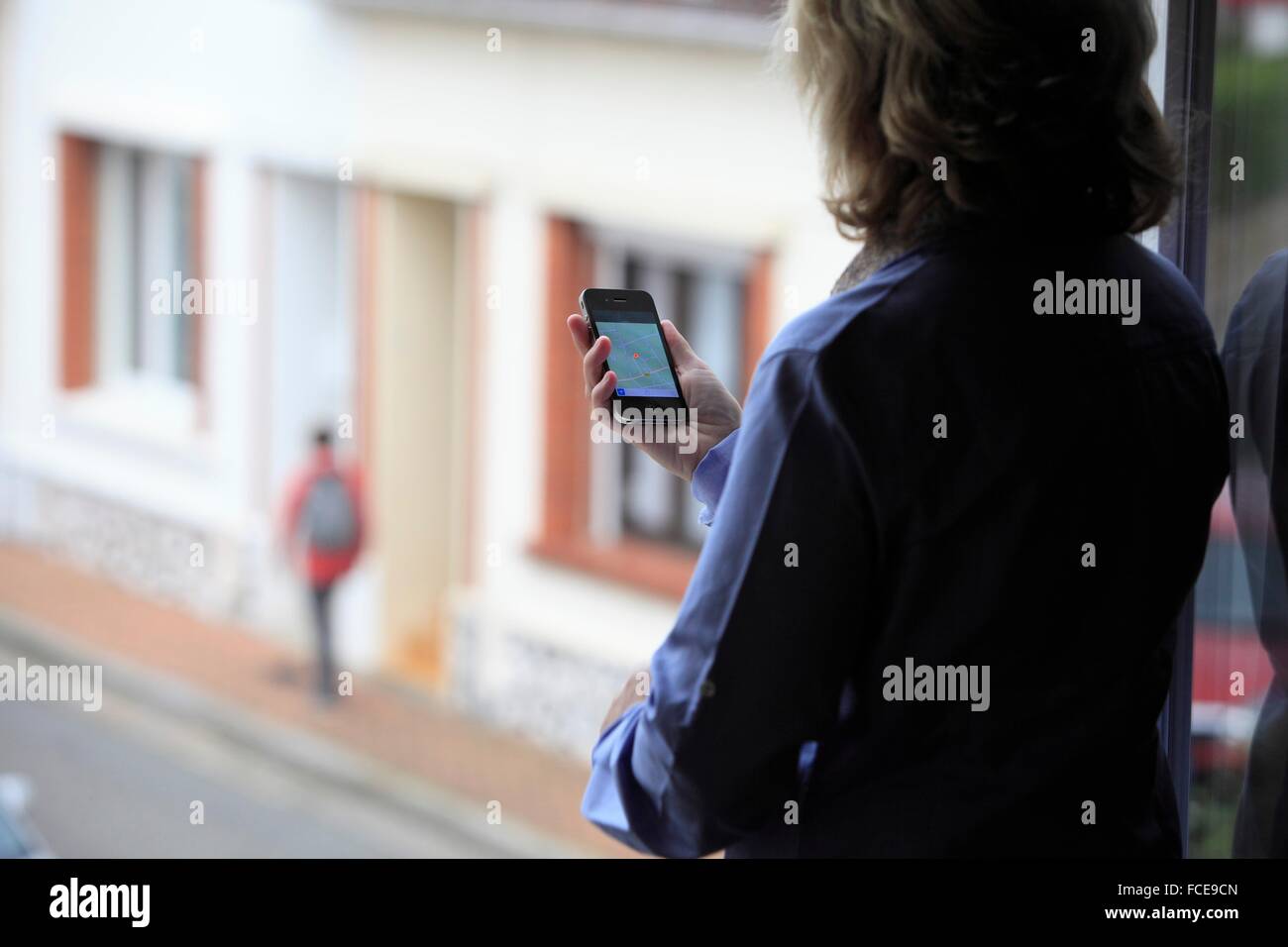 France, mother supervising her son thanks to an application of cellphone localization Stock Photo