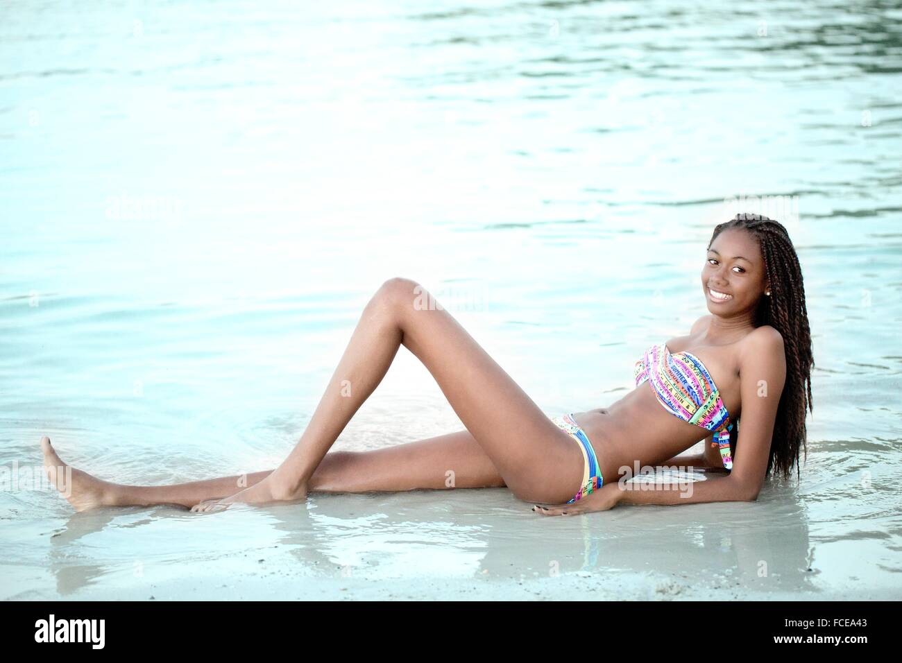 West indian smiling young girl in swimsuit Stock Photo - Alamy