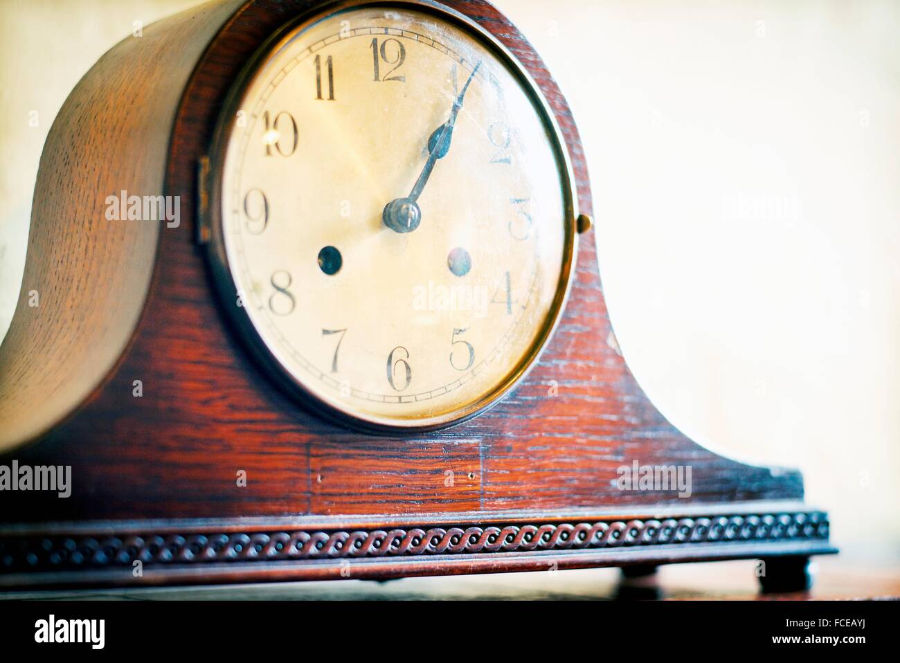 Old wooden mantel clock, on a mantelpiece at 13, 05h. Mahon, Menorca