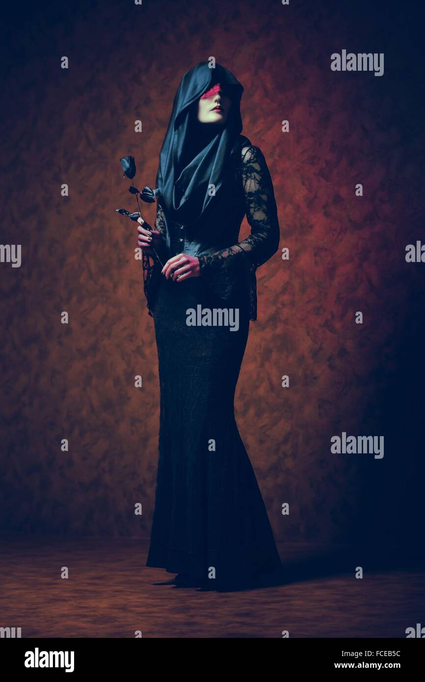 Gothic woman holding a rose Stock Photo - Alamy