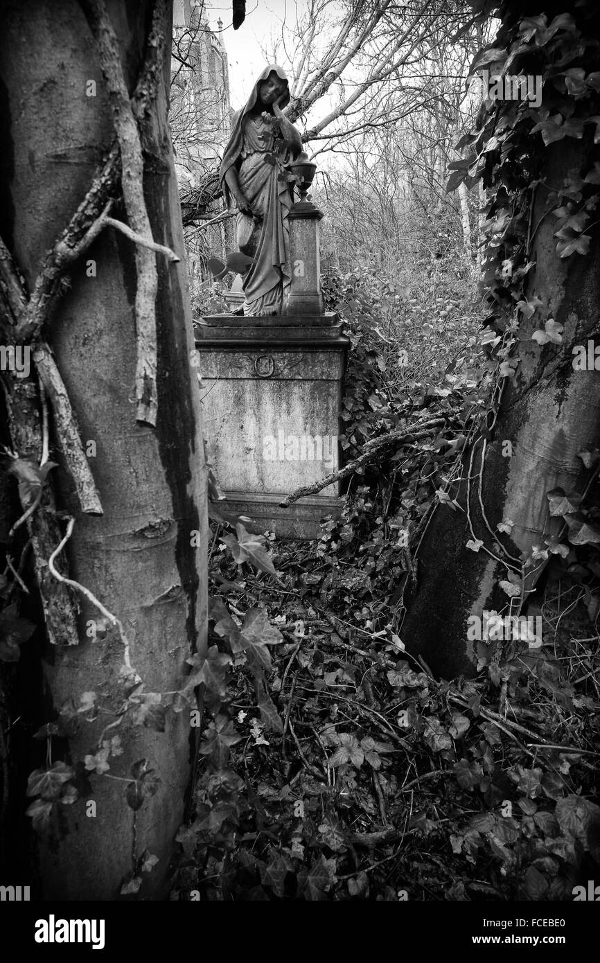 Black and white photography of the obituary symbolism of a grave with a female figure in abney park cemetery stoke newington
