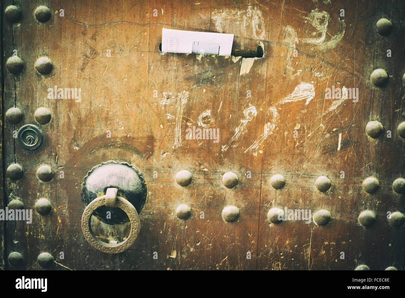 Old door handle with ring, and a letter in a mailbox door. Fez medina