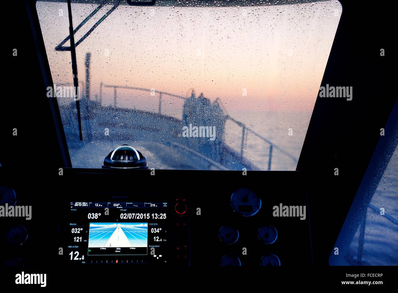 wheelhouse of a fishing boat at dawn with autopilot and compass. Mediterranean Sea. Europe Stock Photo