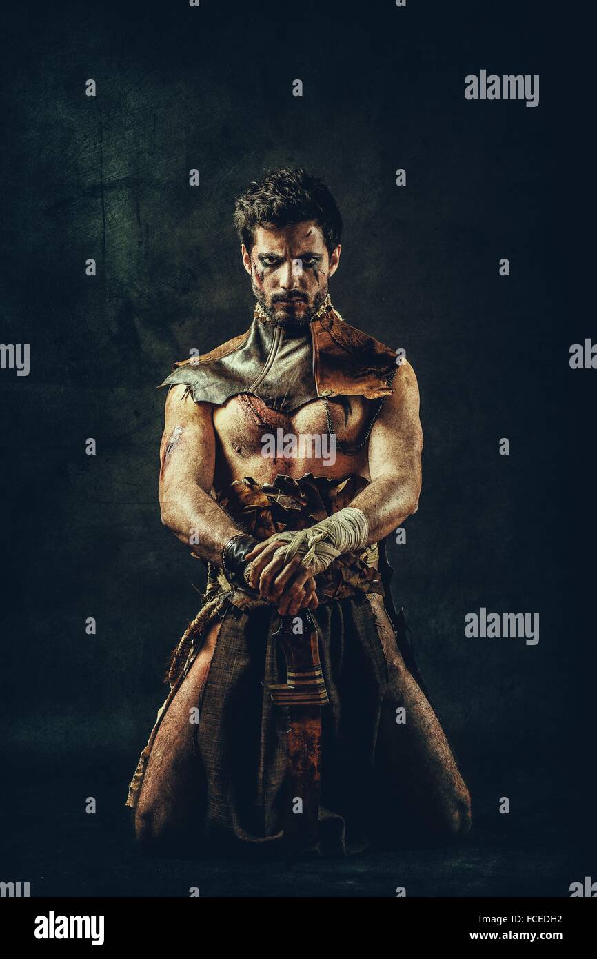 Tribal warrior kneeling Stock Photo Alamy