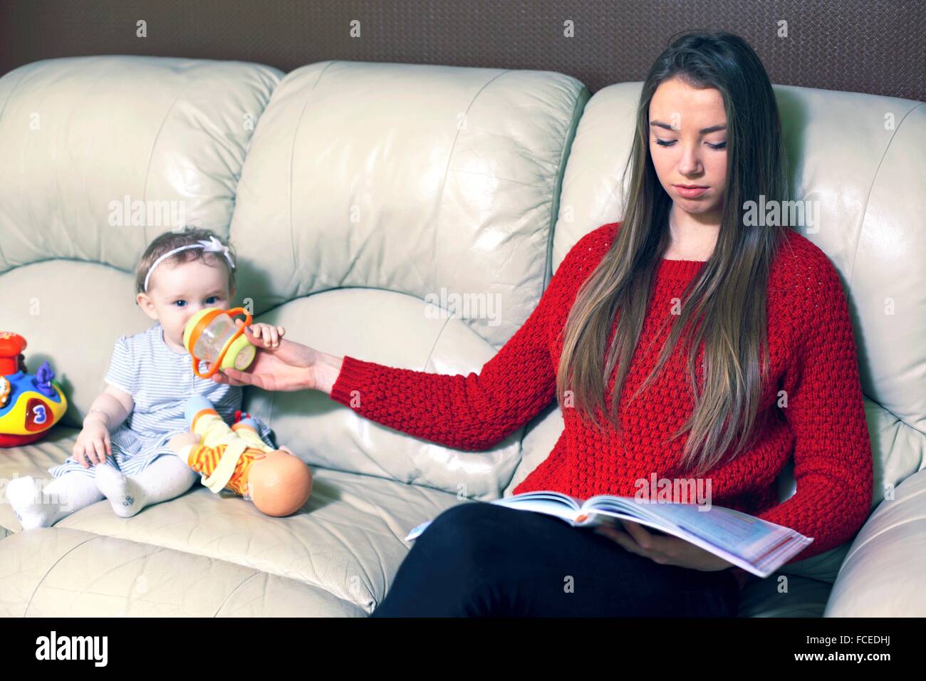 France, nanny or very new mother in the living room Stock Photo