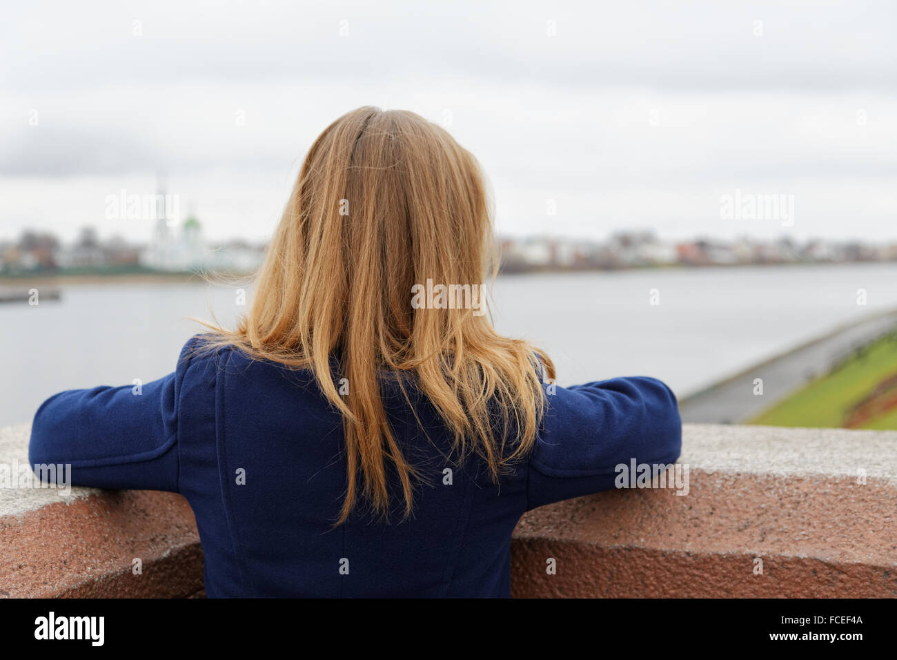 girl looks at the embankment of the river in the fall Stock Photo - Alamy