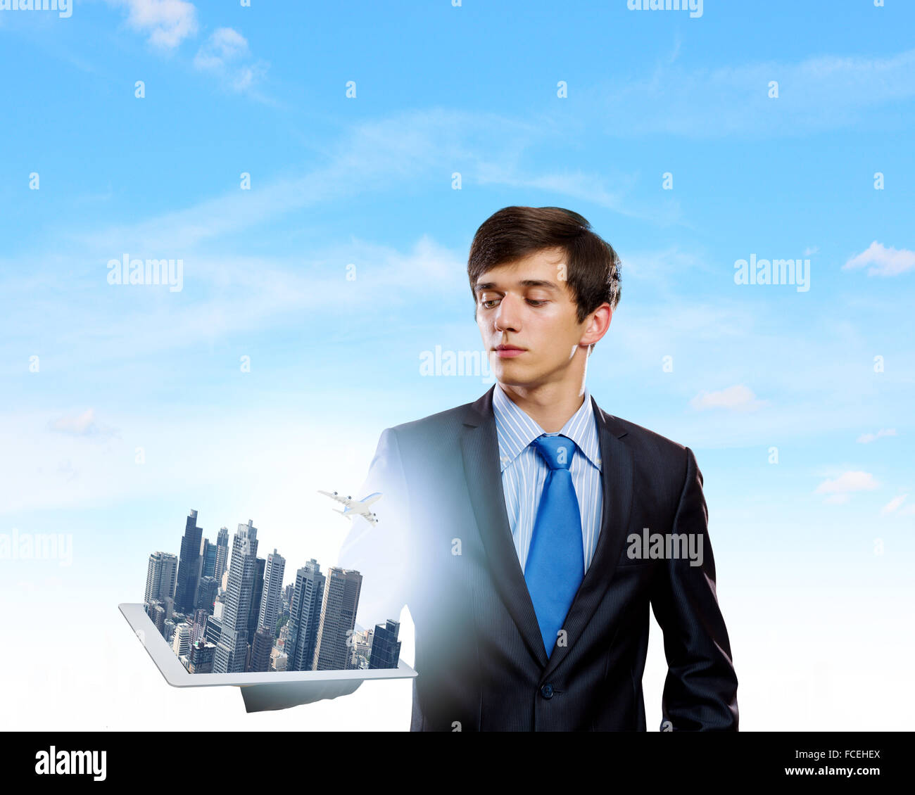 Handsome businessman holding model of modern city Stock Photo - Alamy