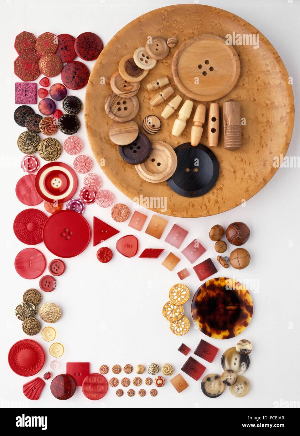 Arrangement of buttons including red and wooden buttons Stock Photo