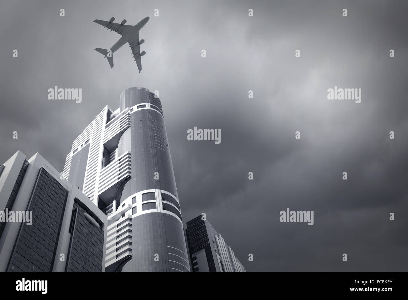 Bottom view of airplane flying above skyscrapers Stock Photo - Alamy