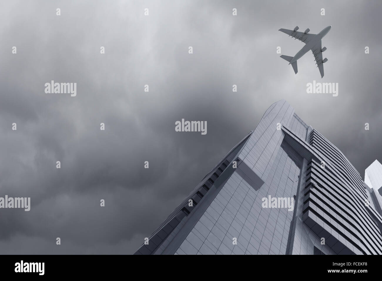 Bottom view of airplane flying above skyscrapers Stock Photo - Alamy