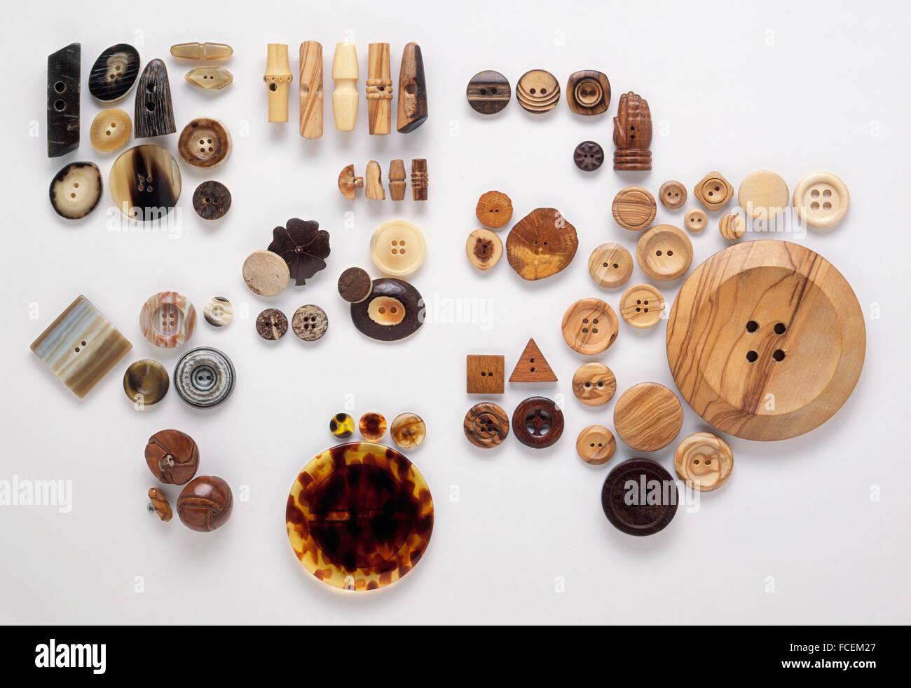 Buttons and toggles carved from wood, fake and real horn, vegetable ivory Corozo nut), coconut shell, fake tortoiseshell, and leather Stock Photo