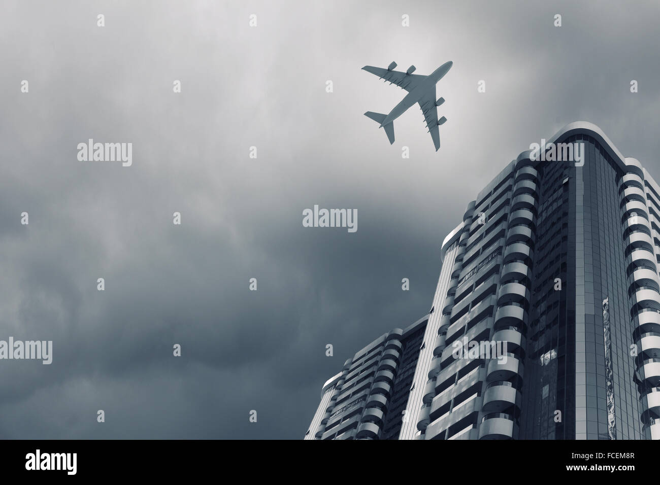 Bottom view of airplane flying above skyscrapers Stock Photo - Alamy