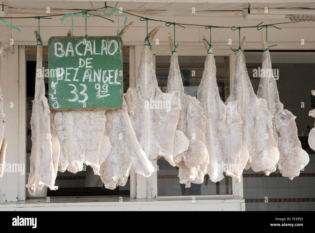 Argentina, Buenos Aires Province, Mar del Plata, Banquina de Pescadores, hanging dried cod for sale at a fishmonger's Stock Photo