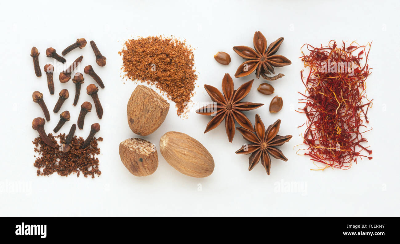 Saffron strands, star anise, whole and ground nutmeg and cloves Stock