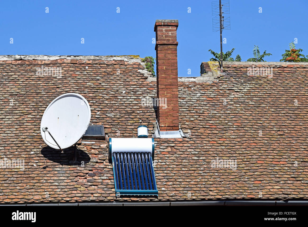 House roof with antenna and solar panel Stock Photo