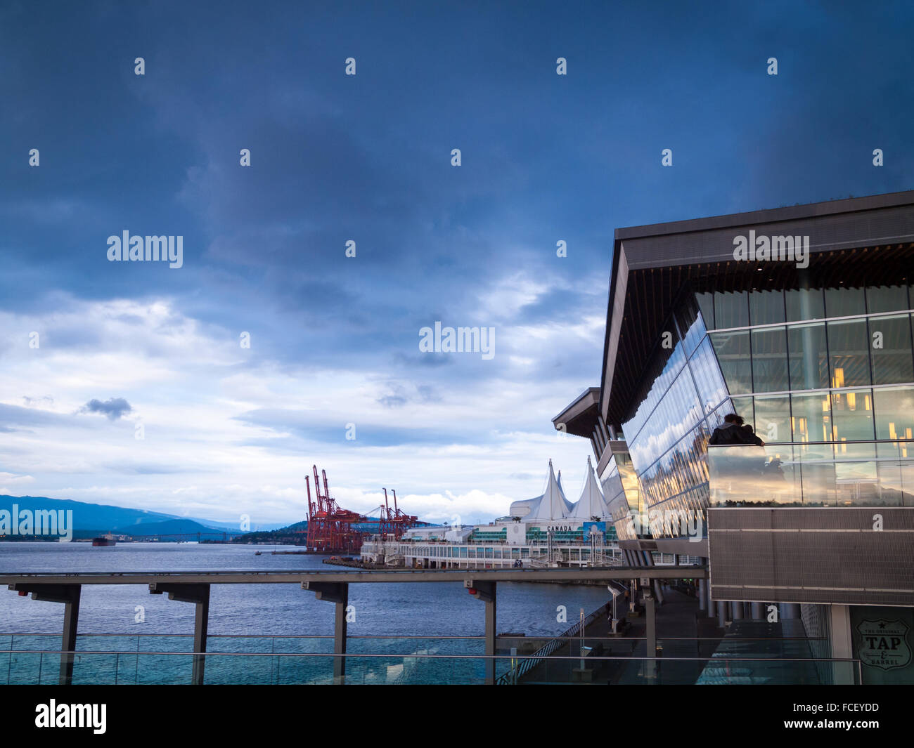 In the foreground, the West Building of the Vancouver Convention Centre. The East Building (Canada Place) is in the background. Stock Photo
