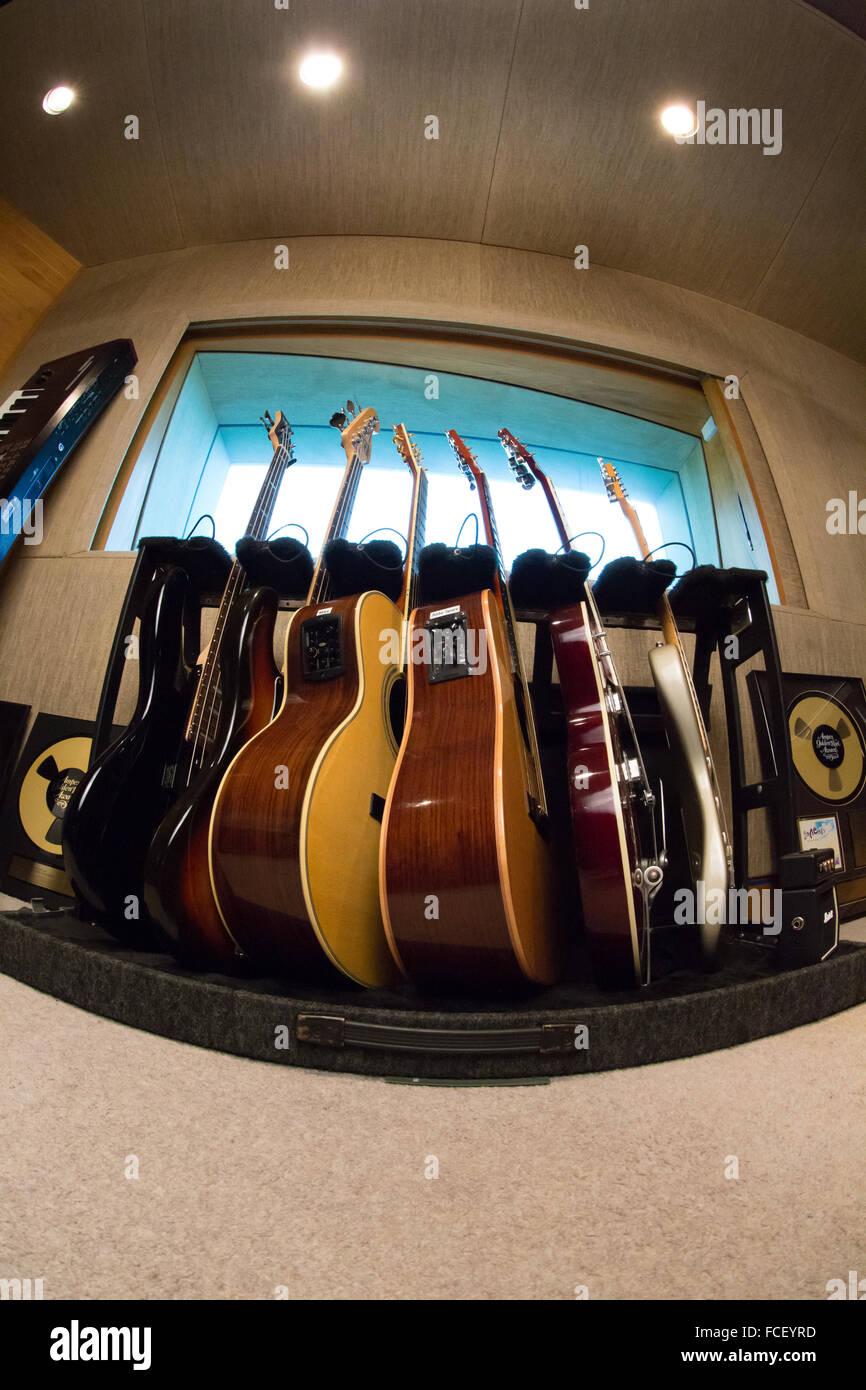 Electric guitars, acoustic guitars and electric bass guitars on a rack