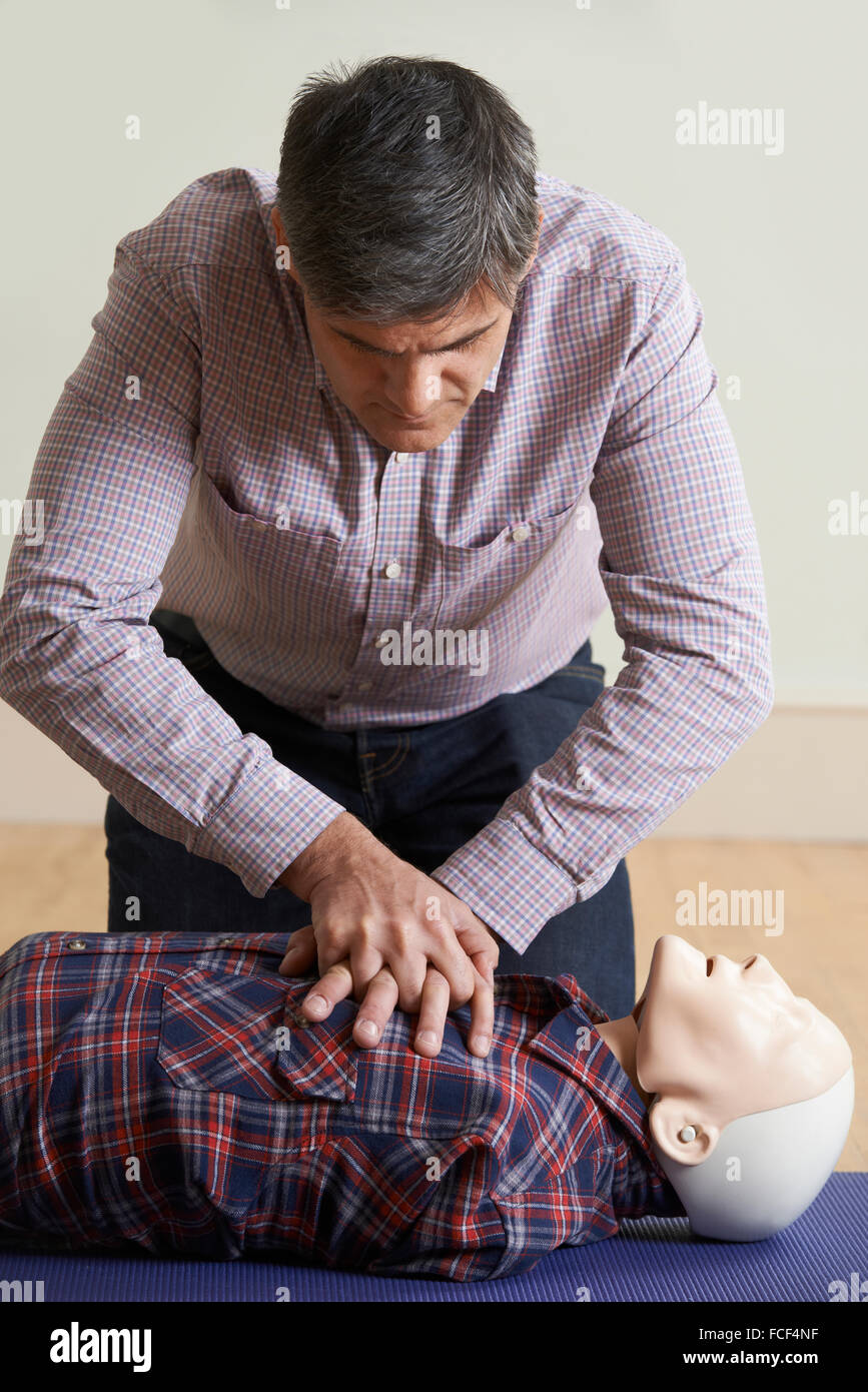 Man Using CPR Technique On Dummy In First Aid Class Stock Photo Alamy