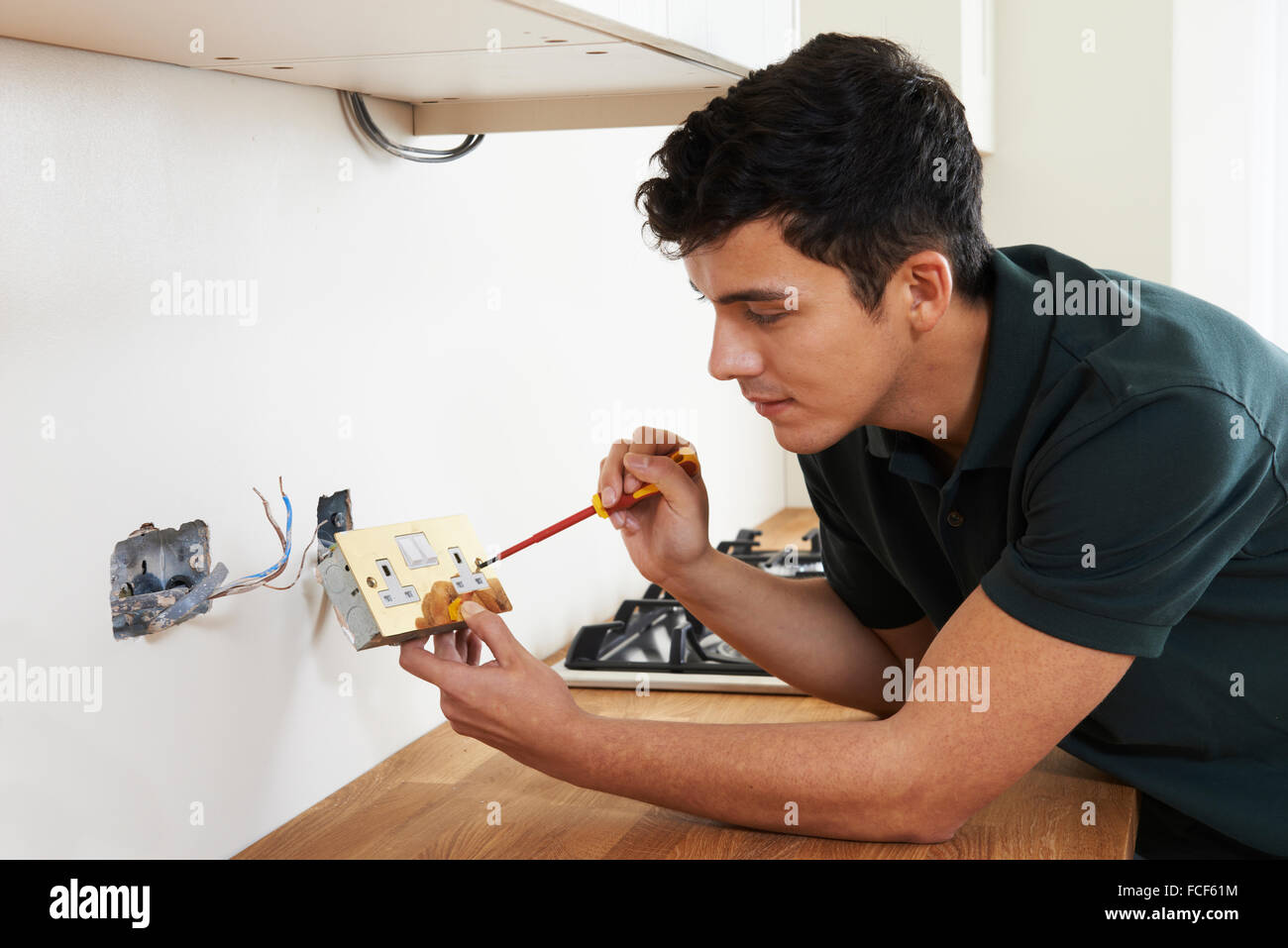 Electrician Installing Socket In New House Stock Photo