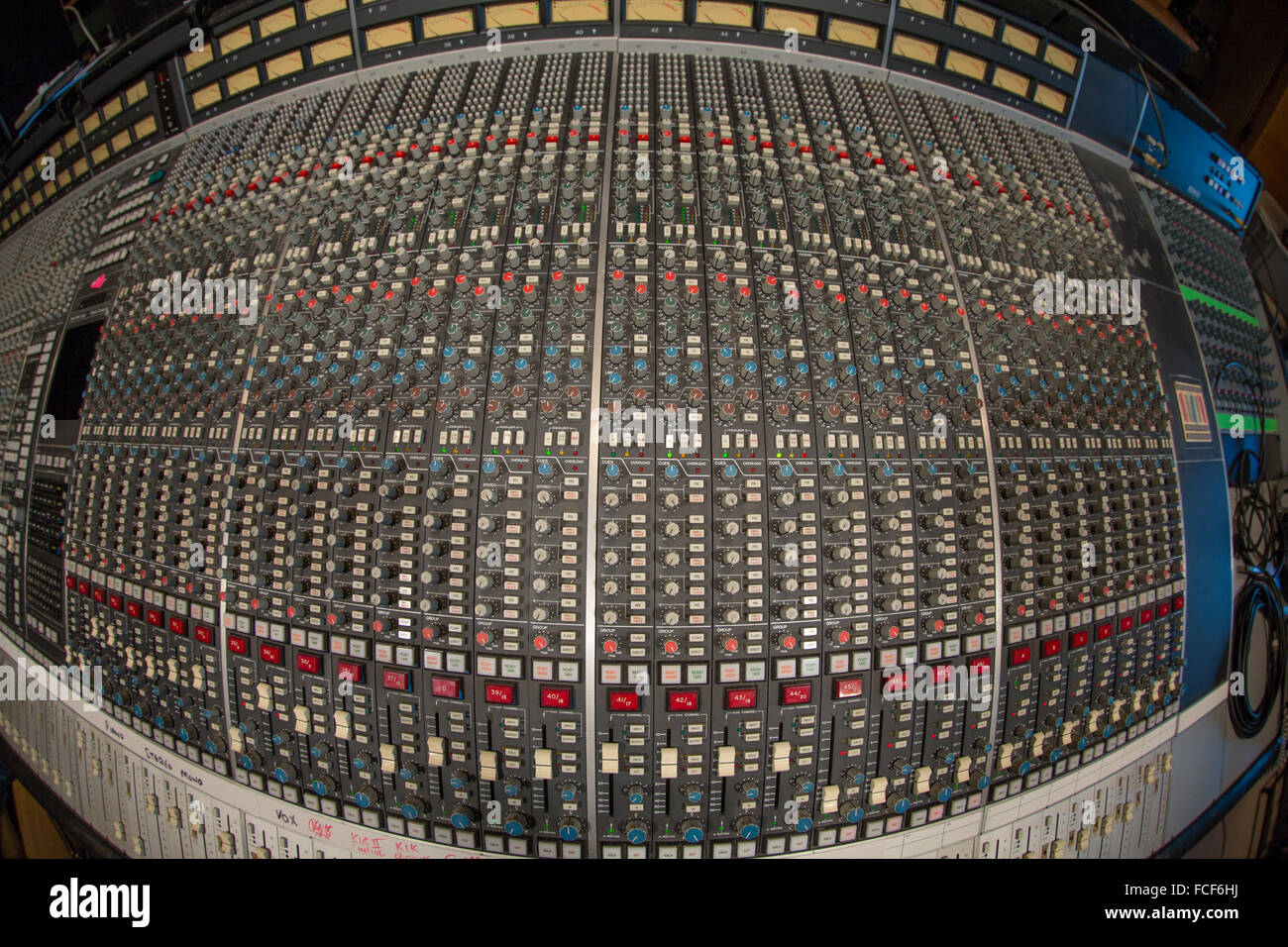 above fish eye view of ssl e series sound mixing desk showing buttons, knobs, controlls and faders Stock Photo
