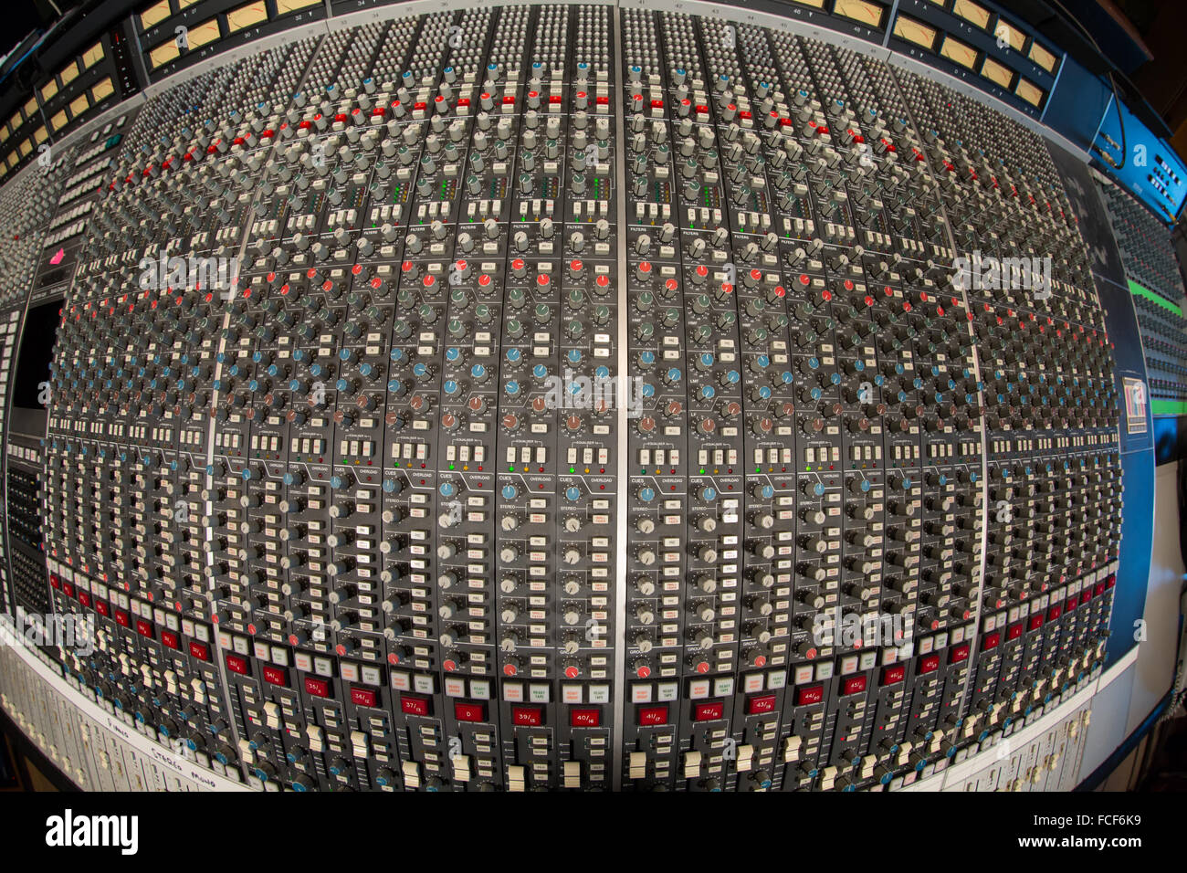 above fish eye view of ssl e series sound mixing desk showing buttons, knobs, controlls and faders Stock Photo