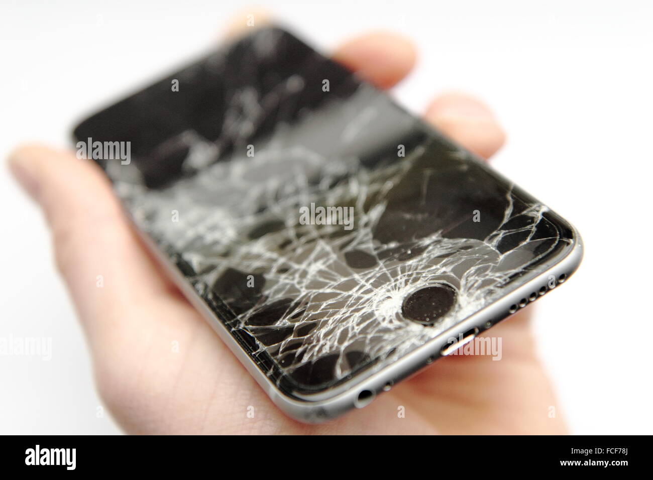 iPhone6 with broken glass hold in hand Stock Photo