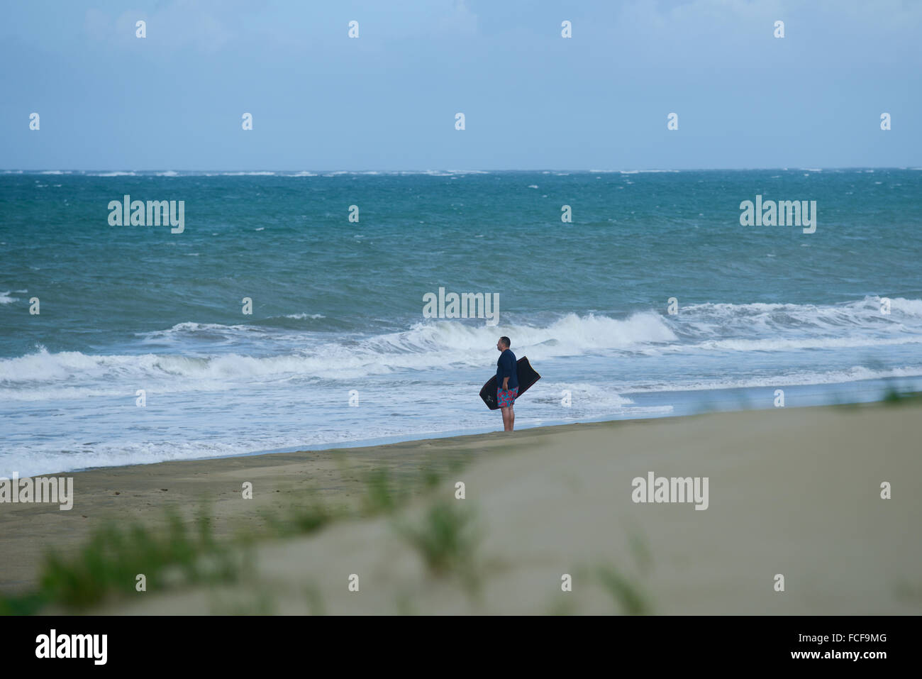 Surfer watching the ocean at Dorado beach. Dorado, Puerto Rico. Caribbean Island. US territory. Stock Photo