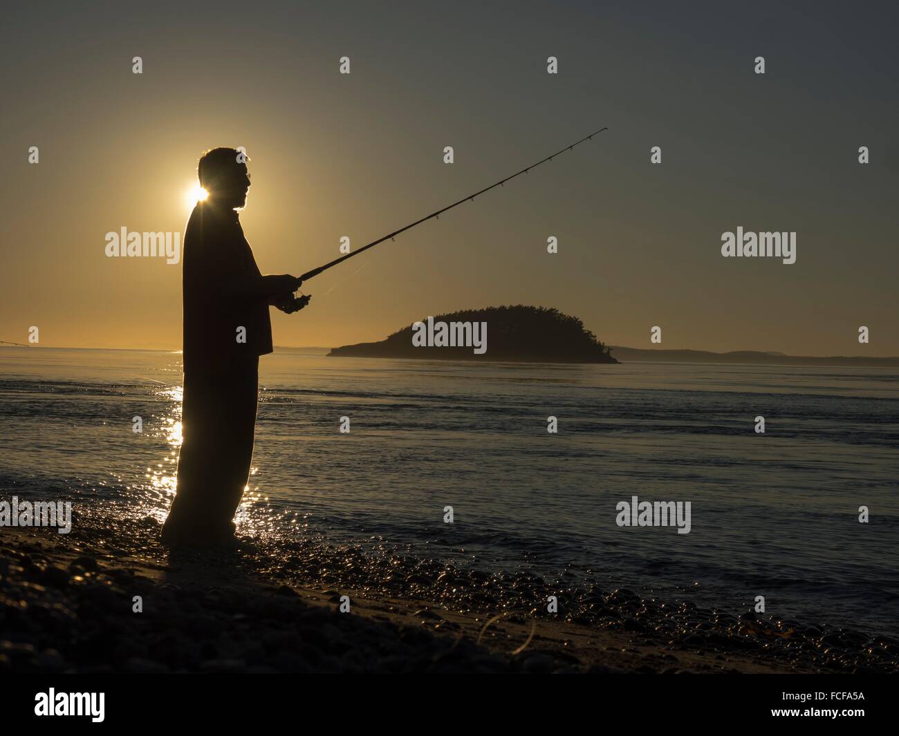 Silhouette of man fishing hi-res stock photography and images - Alamy