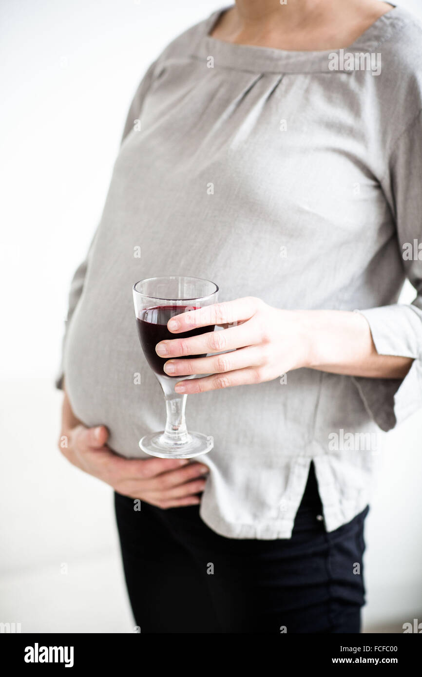 Pregnant woman with a glass of wine Stock Photo Alamy