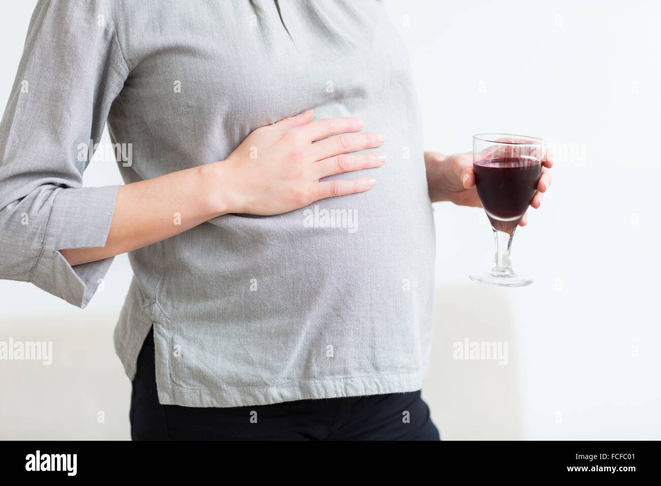 Pregnant woman with a glass of wine. Stock Photo