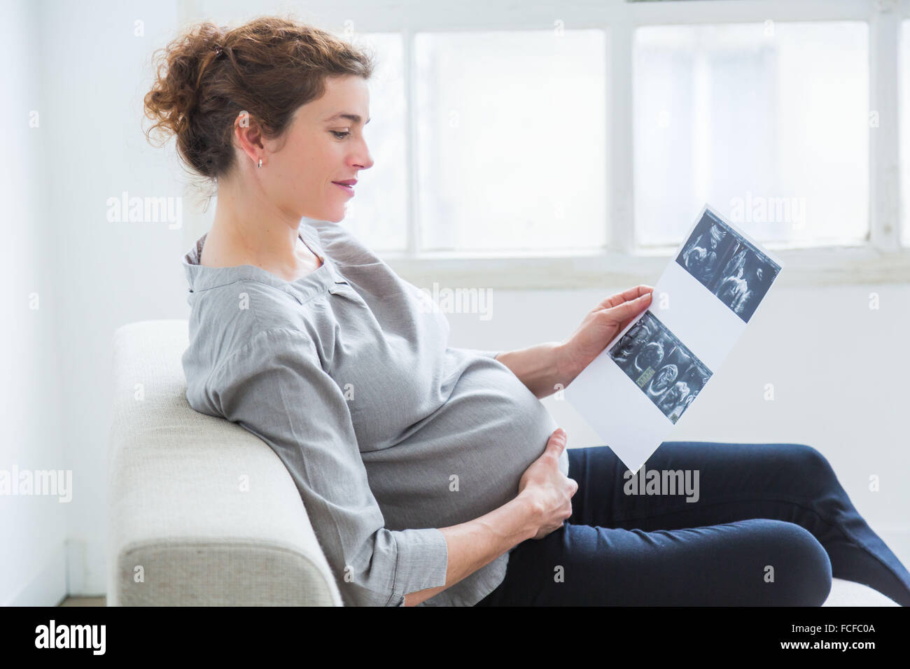 Woman looking at baby scan. Stock Photo