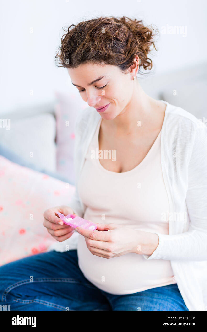 Woman taking medication during pregnancy Stock Photo Alamy