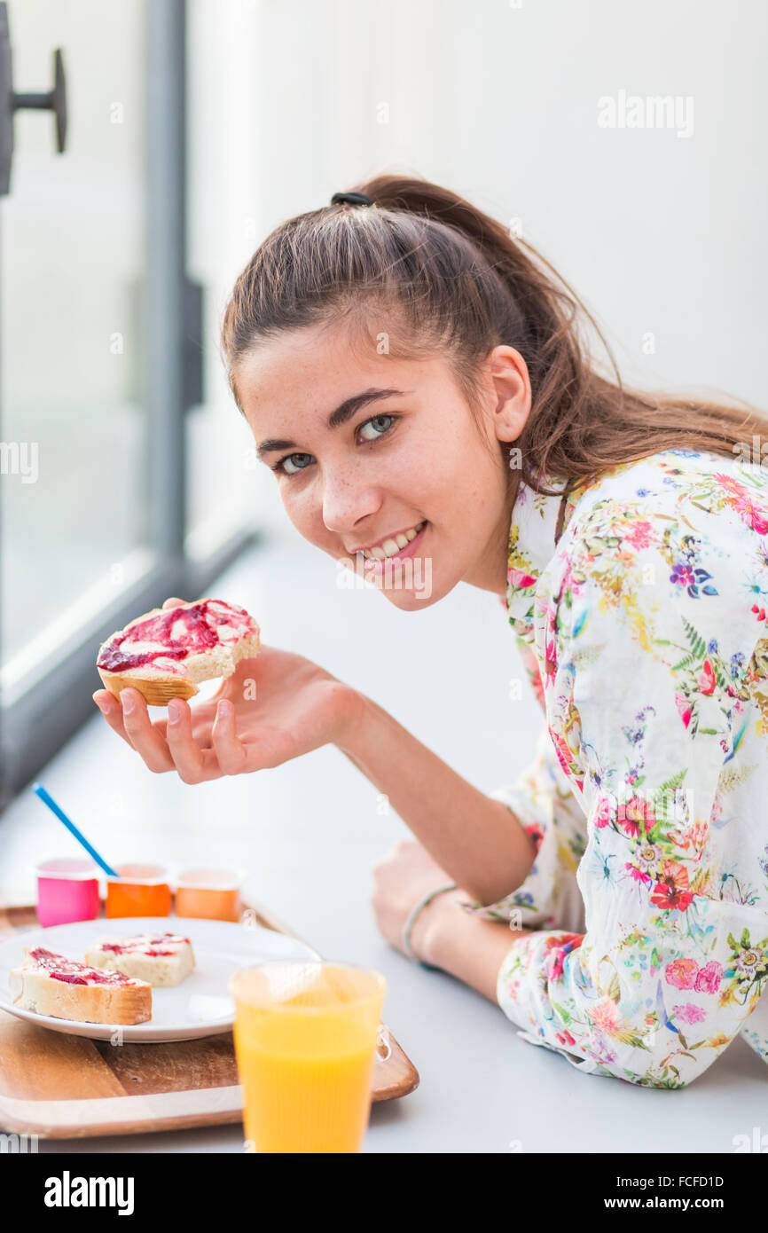 Woman eating a jam sandwich Stock Photo Alamy