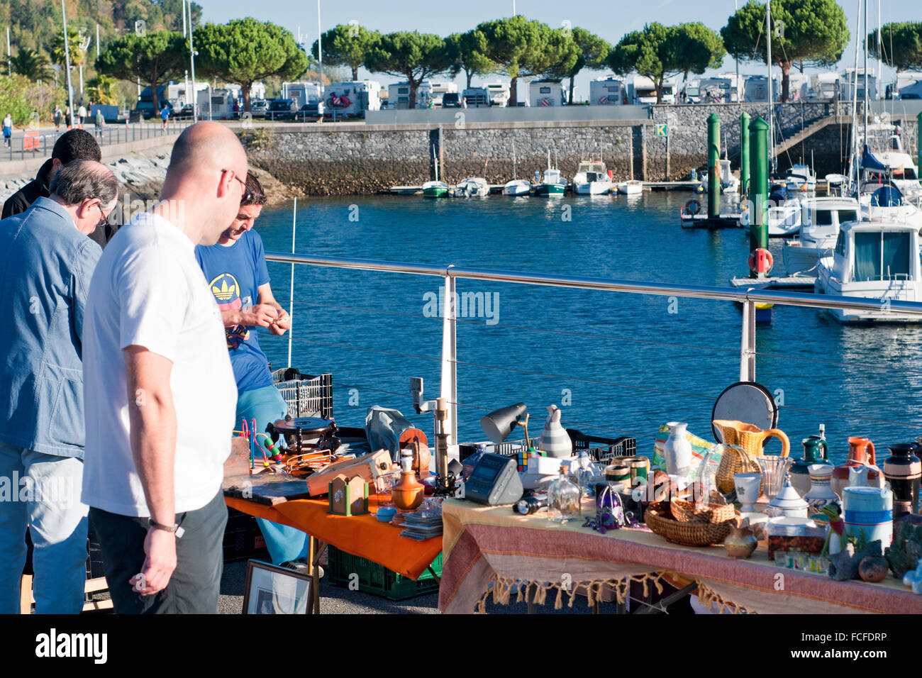 People shopping at a local market in Hondarribia marina with yachts moored in the background. Basque Country, Spain. Stock Photo